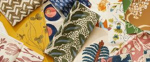 assorted colorful and patterned textiles in a warm palette.