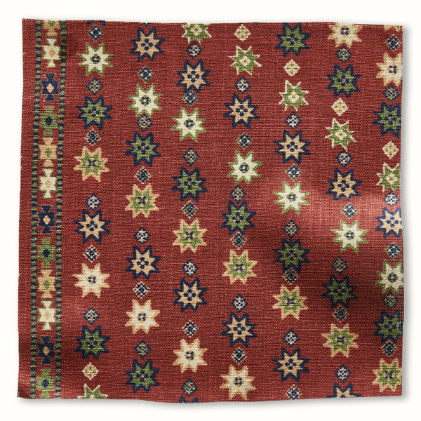 Red patterned throw pillow cover with multicolor star and geometric motifs