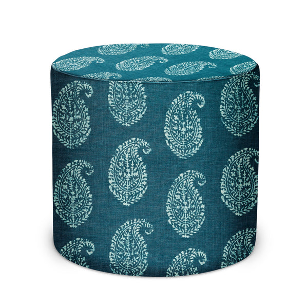 Indoor pouf with cylindrical shape and teal paisley pattern on dark indigo fabric