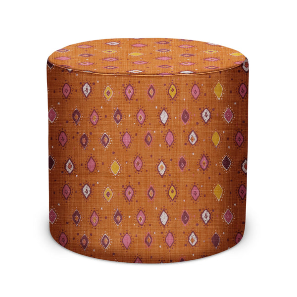 Orange fabric indoor pouf with pink and purple teardrop pattern, round upholstered top