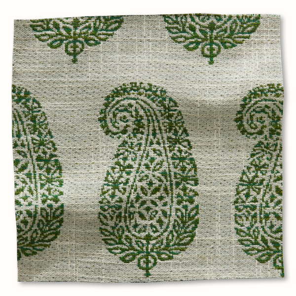 Outdoor pillow cover with green-and-white ornamental medallion pattern, woven texture