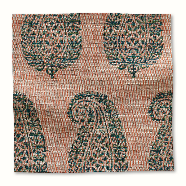 Outdoor pillow in jade and terracotta with geometric floral pattern