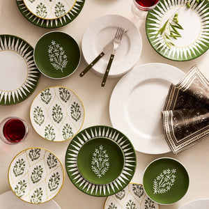 Assorted salad plates with olive green and white designs featuring botanical sprigs