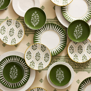 Assorted salad plates in olive green and white with botanical sprigs and sunburst rims