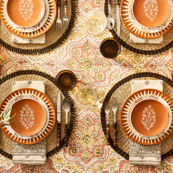 Orange spice jaali salad plate with orange center, white tree motif, and gold rim