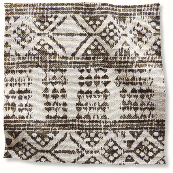 Geometric patterned pillow cover in natural cream with dark brown accents.