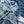 Indigo Indian bedcover close-up: blue fabric with white stripes and tassel fringe