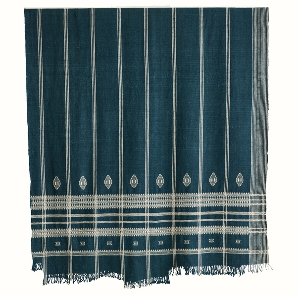 Indigo Indian bedcover with vertical stripe pattern and white motifs, fringed edge