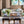 Light beige tufted sofa with two seat cushions and accent pillows