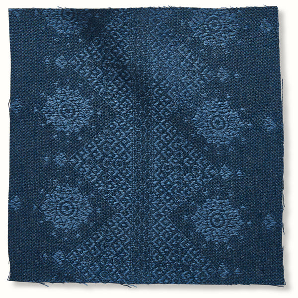 Outdoor pillow cover with dark indigo geometric medallion pattern, square fabric
