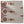Outdoor red geometric medallion print pillow on natural woven fabric