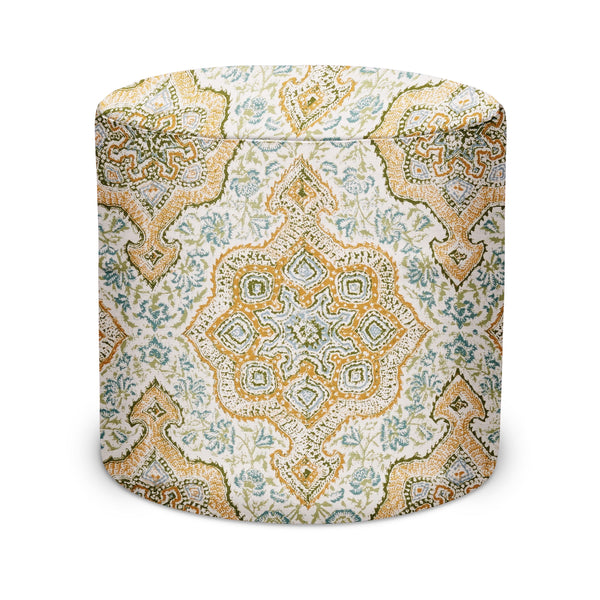 Round indoor pouf upholstered in gold and olive ornate medallion pattern on light fabric