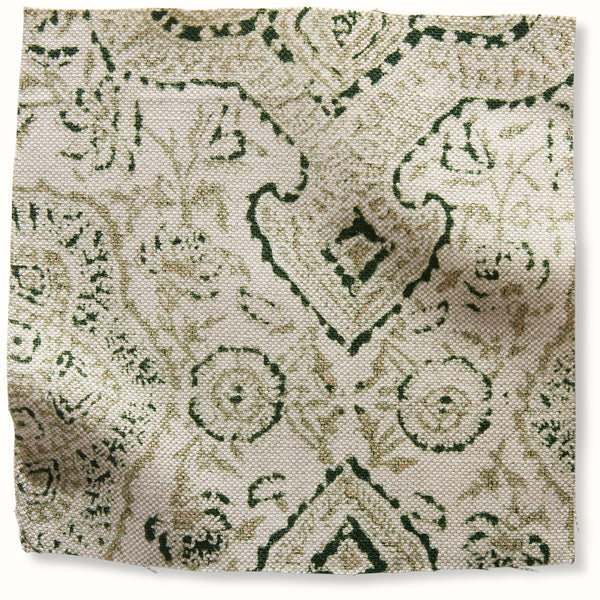 Green floral and vine patterned pillow cover fabric on tan background