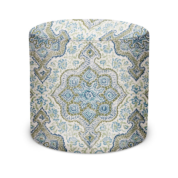 Indoor pouf with round top, off-white base and blue/indigo geometric print upholstery.