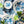 Hand-painted blue fig blossom appetizer plate, surrounded by matching plates and flatware