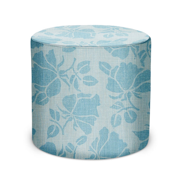Blue upholstered fabric pouf ottoman with light leaf pattern, cylindrical design