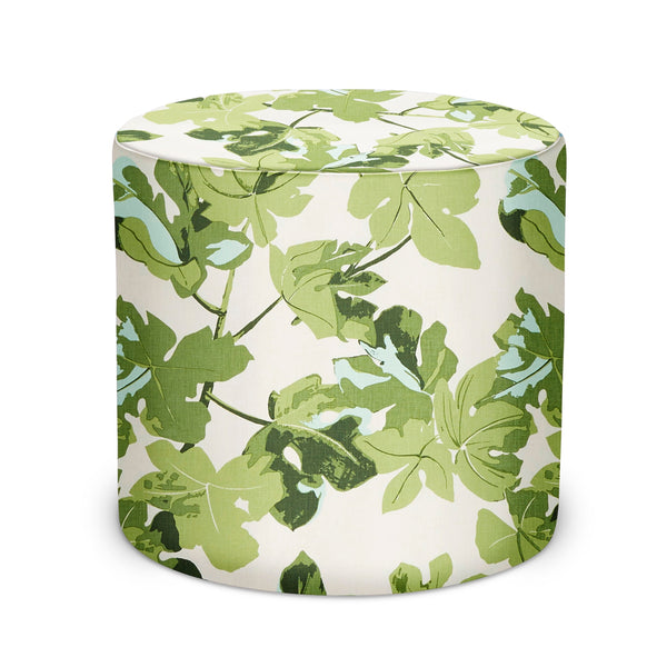 Indoor pouf with cylindrical shape and green fig leaf pattern on light fabric