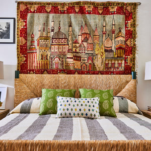 Perriand Rush Bed with light rush headboard and bench base, with patterned pillows