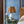 Ceramic jug table lamp with pleated multicolor drum shade and side loop handles