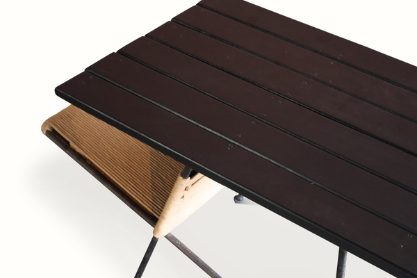 Dark slatted tabletop with iron frame and tan woven lower shelf on side table pair