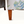 Wood armchair legs with floral upholstery, light gray base fabric and blue-green leaf pattern
