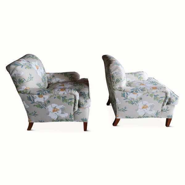Pair of floral side-view armchairs with dark wood legs, light gray upholstery and blue-green leaves