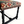 Close-up of kilim bench seat edge with multicolor geometric woven pattern on dark wood leg