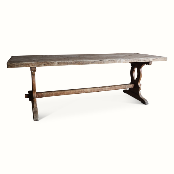 Antique French oak refectory table with side view of trestle base and thick plank top