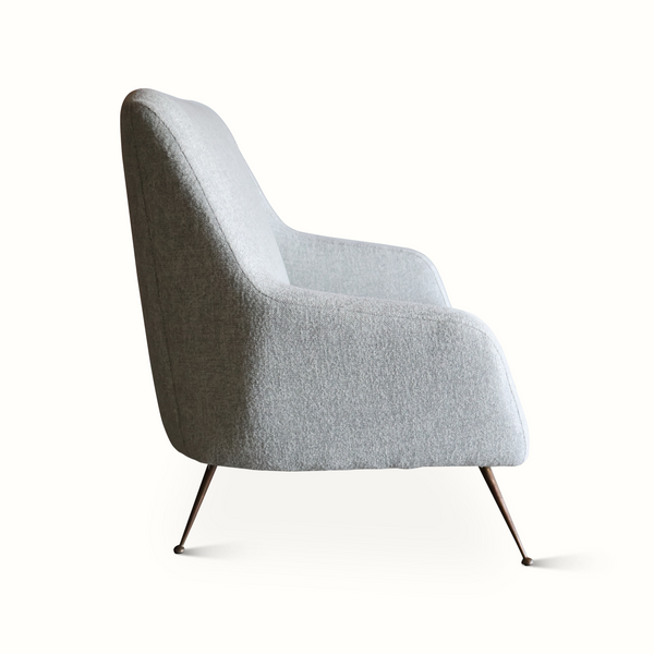 Light gray upholstered mid-century settee with rounded back and curved armrests on legs.