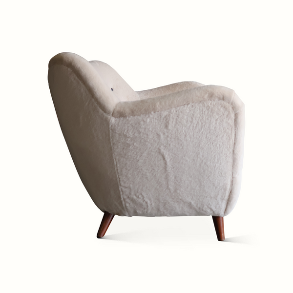 Side view of light gray upholstered sofa with tall arms and tapered dark wooden legs.