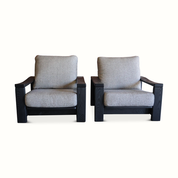 Pair of elm armchairs with striped light blue linen seat cushions and dark wood frames
