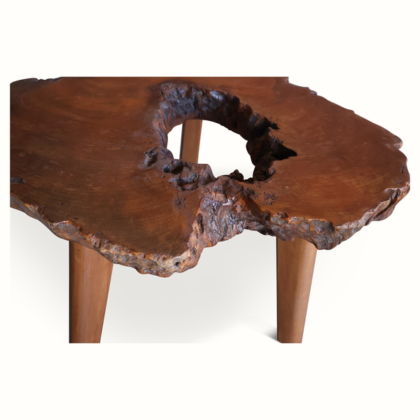 Live edge side table, close view of blue resin knot holes on wooden top, two legs.