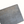 Close-up of ceramic block sculpture with engraved signature and numbers