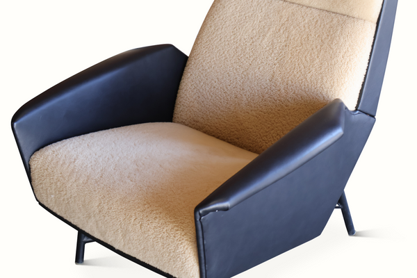 Lounge chair arm and seat with beige sheepskin cushion and dark blue leather sides