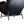 Dark leather lounge chair with curved armrests and metal legs, three-quarter side view