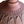 Ceramic lamp base close-up with carved relief pattern and speckled terracotta finish