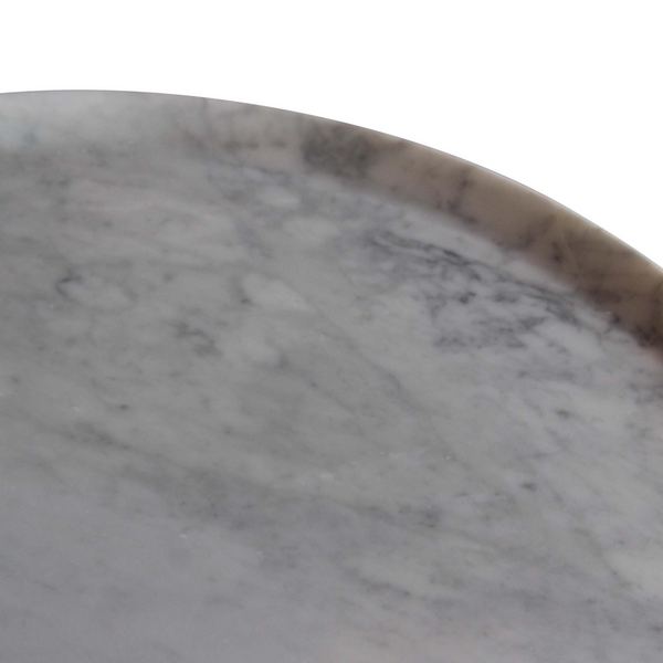 Close-up of round marble tabletop with light gray and brown veining, curved rim