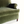 Green velvet sofa arm and seat detail with rolled arm and stitched seam trim