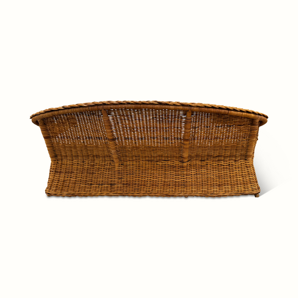 Wicker sofa with striped cushion, side profile and woven frame