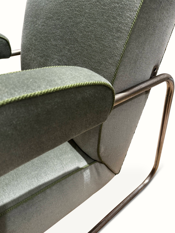 Reclining chair arm and back corner with contrast green piping and chrome support
