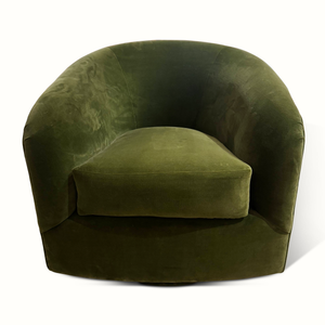 Green velvet swivel chair with rounded arms, deep seat, and curved back, front view.