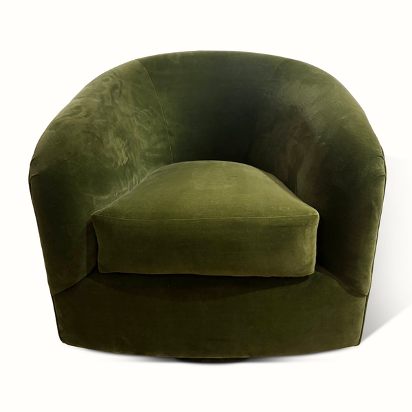 Green velvet swivel chair with rounded arms, deep seat, and curved back, front view.