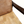 Patchwork leather armchair close-up: tan seat cushion with stitched square patchwork