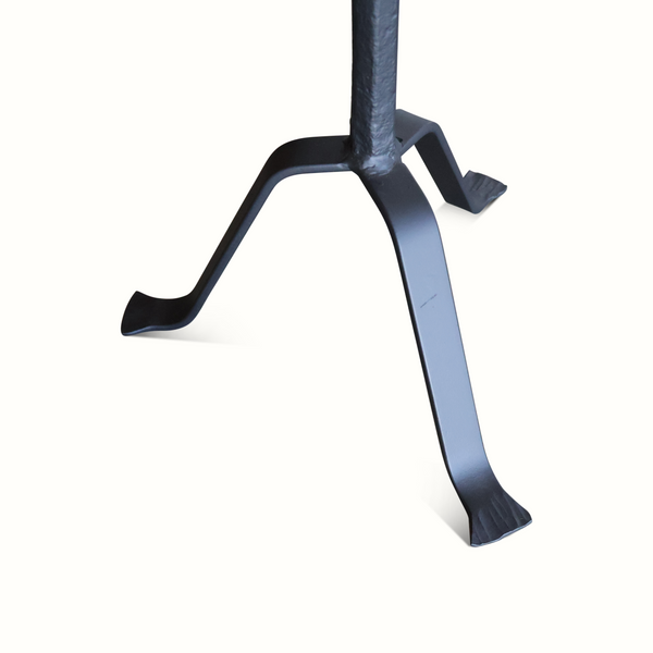 Black gueridon table with splayed three-leg base attached to pedestal