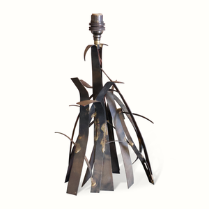 Brutalist metal table lamp with exposed socket and dark sculpted blade base