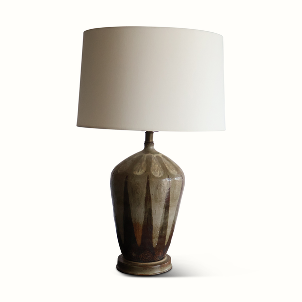 Ceramic table lamp with white drum shade; dark olive-brown speckled glazed base