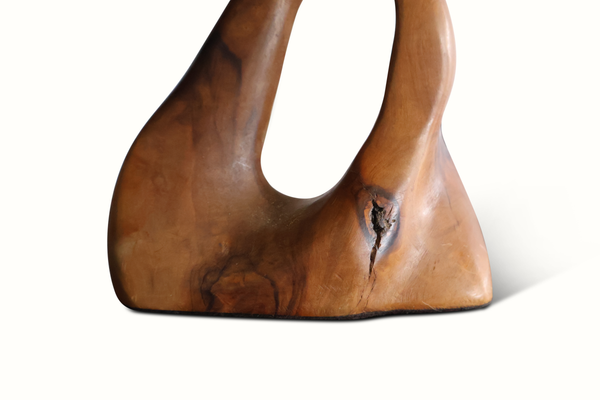 Olive wood lamp detail of carved warm-brown base with oval cutout window