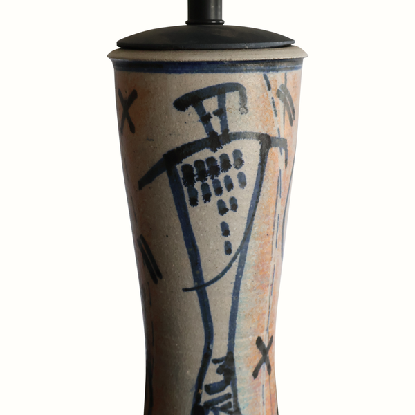 Pottery table lamp ceramic body close-up with blue abstract figures and black rim cap