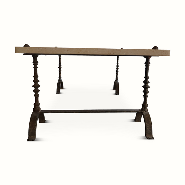 Limestone-topped wrought iron table with rectangular top and four arched base feet