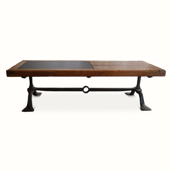Coffee table front view with oak top, inset slate panel, and forged iron X-bar legs.